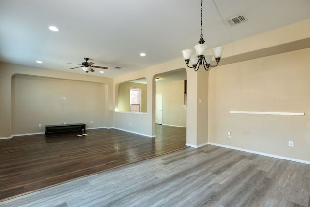 1244 Yellow Iris Rd, Leander, TX 78641 - unfurnished living room featuring wood finished floors, arched walkways, recessed lighting, a ceiling fan, and a chandelier