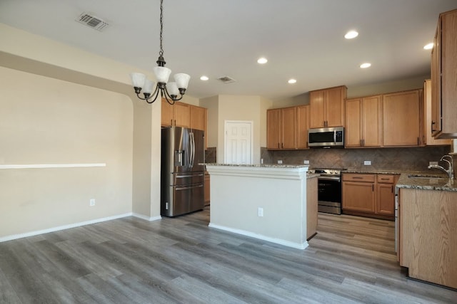 1244 Yellow Iris Rd, Leander, TX 78641 - kitchen featuring stainless steel appliances, light wood-style flooring, backsplash, recessed lighting, and light stone countertops