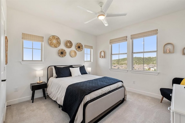 6901 Davenport Divide Rd, Austin, TX 78738 - bedroom with baseboards, light carpet, and ceiling fan