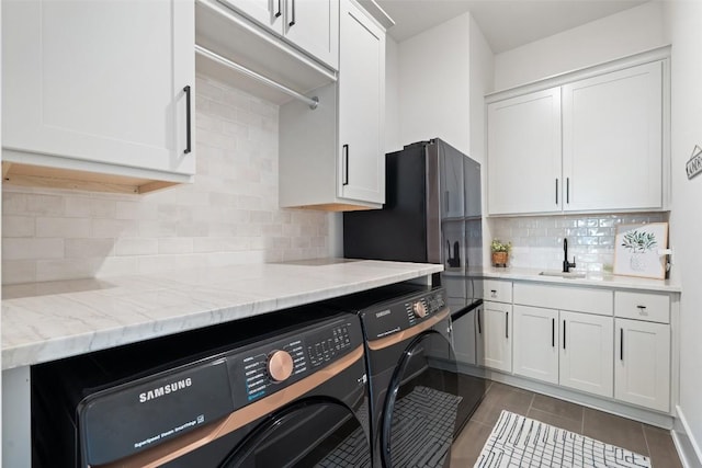 6901 Davenport Divide Rd, Austin, TX 78738 - kitchen with independent washer and dryer, white cabinets, a sink, and dark tile patterned flooring