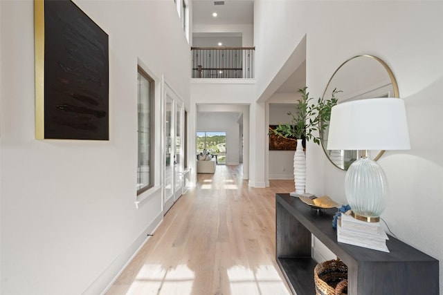 6901 Davenport Divide Rd, Austin, TX 78738 - corridor featuring light wood finished floors, a towering ceiling, and baseboards
