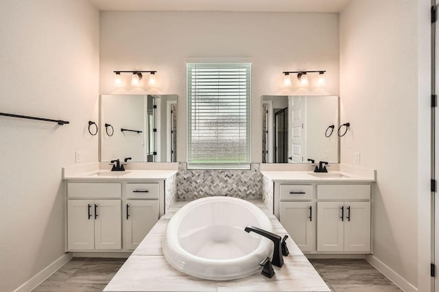 461 Constitution Way, Kyle, TX 78640 - bathroom with two vanities, a bath, a stall shower, and baseboards