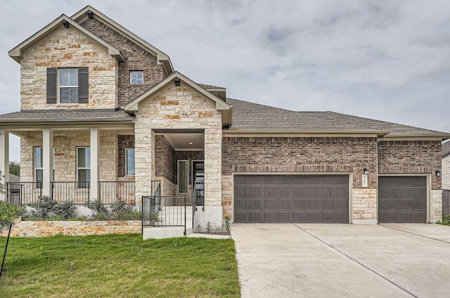 461 Constitution Way, Kyle, TX 78640 - view of front of property with an attached garage, concrete driveway, stone siding, roof with shingles, and a porch
