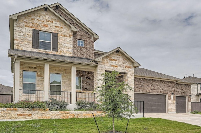 461 Constitution Way, Kyle, TX 78640 - view of front of property with stone siding, a porch, a garage, driveway, and a shingled roof
