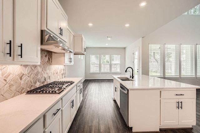 461 Constitution Way, Kyle, TX 78640 - kitchen with appliances with stainless steel finishes, dark wood-style flooring, a sink, tasteful backsplash, and light countertops