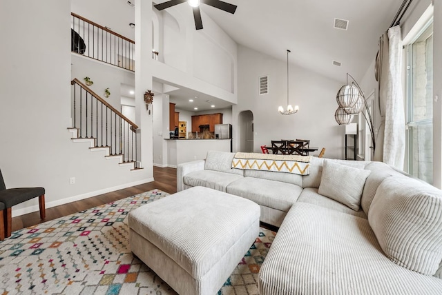 4404 Cierne Cv, Round Rock, TX 78681 - living room featuring a chandelier, dark wood-style flooring, a ceiling fan, baseboards, and high vaulted ceiling