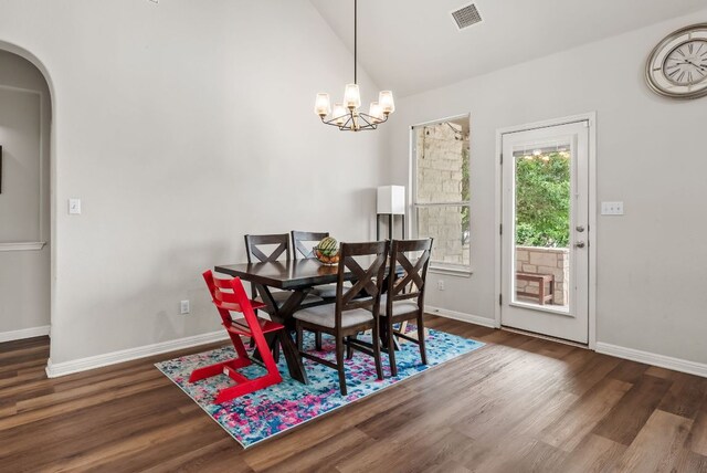4404 Cierne Cv, Round Rock, TX 78681 - dining space with arched walkways, wood finished floors, a chandelier, baseboards, and lofted ceiling
