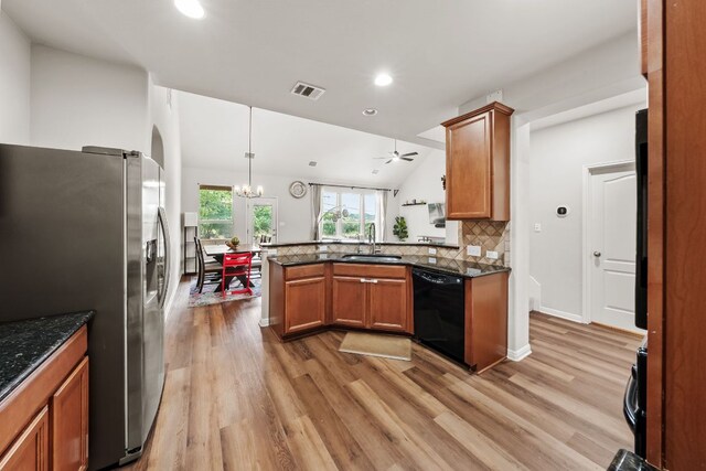 4404 Cierne Cv, Round Rock, TX 78681 - kitchen featuring dishwasher, stainless steel refrigerator with ice dispenser, brown cabinetry, light wood finished floors, and recessed lighting