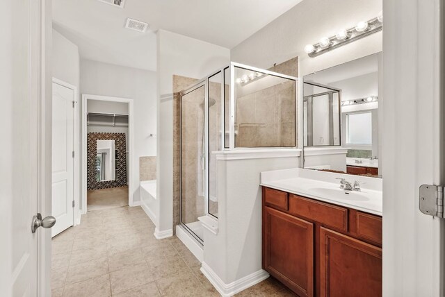 4404 Cierne Cv, Round Rock, TX 78681 - full bathroom featuring a stall shower, vanity, a bath, tile patterned flooring, and a closet