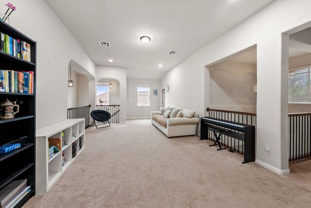 4404 Cierne Cv, Round Rock, TX 78681 - living area with an upstairs landing, carpet floors, arched walkways, and baseboards
