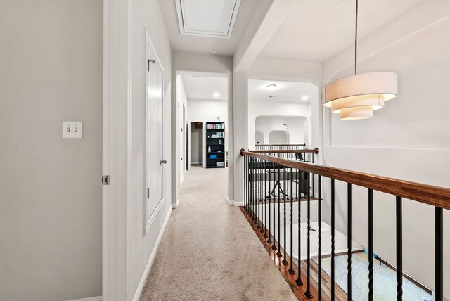 4404 Cierne Cv, Round Rock, TX 78681 - hallway with attic access, an upstairs landing, carpet floors, and baseboards