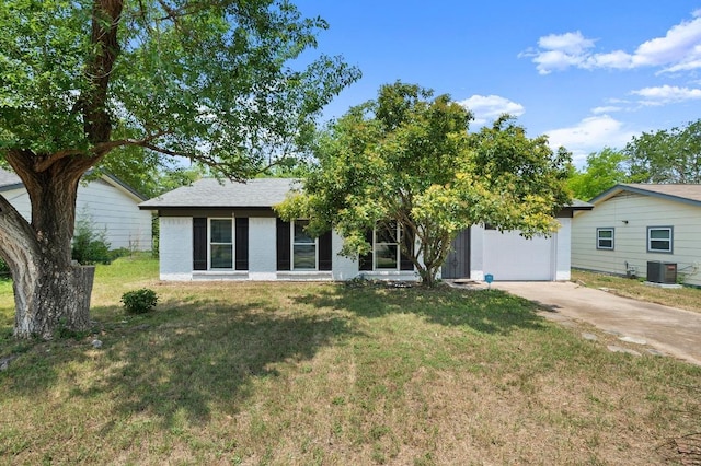 5808 Cedardale Dr, Austin, TX 78745 - view of front facade featuring a garage, concrete driveway, central air condition unit, and a front yard