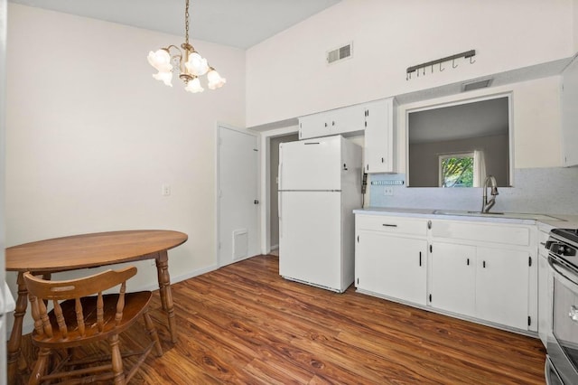 5808 Cedardale Dr, Austin, TX 78745 - kitchen with freestanding refrigerator, stainless steel range, a chandelier, light countertops, and white cabinetry