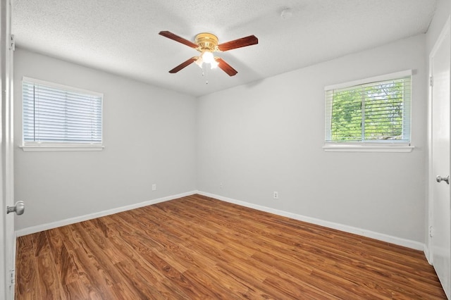 5808 Cedardale Dr, Austin, TX 78745 - unfurnished room featuring a ceiling fan, wood finished floors, baseboards, and a textured ceiling