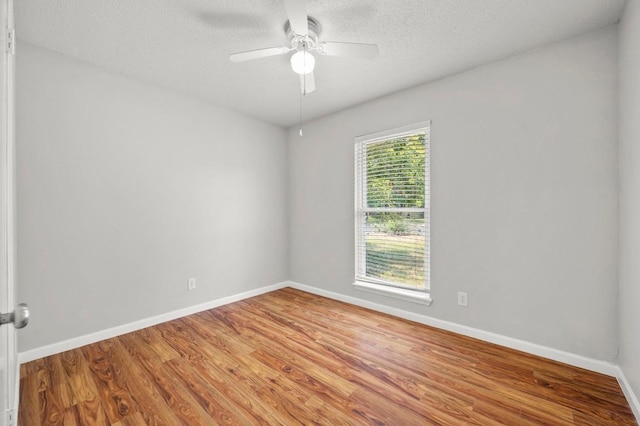 5808 Cedardale Dr, Austin, TX 78745 - unfurnished room featuring wood finished floors, ceiling fan, baseboards, and a textured ceiling