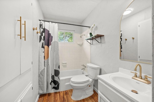5808 Cedardale Dr, Austin, TX 78745 - bathroom with a textured ceiling, wood finished floors, toilet, vanity, and shower / tub combo