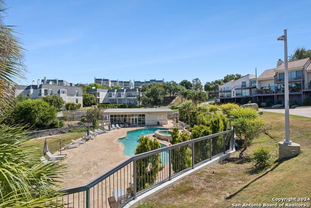 2918 Ranch Road 620th Rd N Unit C122, Austin, TX 78734 - view of swimming pool featuring a patio, a pool with connected hot tub, and a residential view