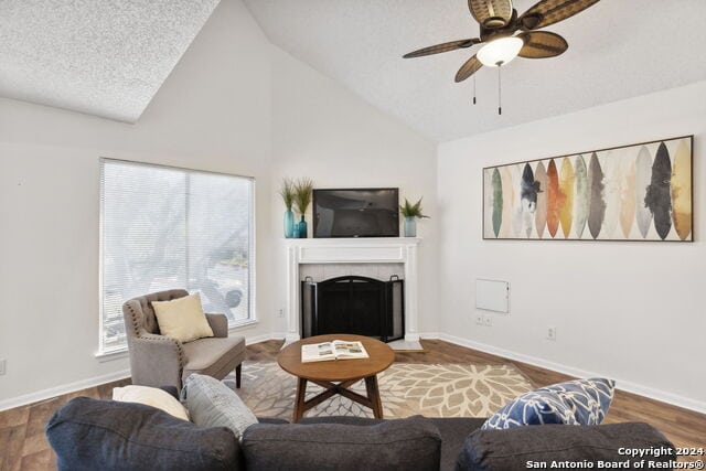 2918 Ranch Road 620th Rd N Unit C122, Austin, TX 78734 - living area with a tiled fireplace, a ceiling fan, wood finished floors, baseboards, and high vaulted ceiling