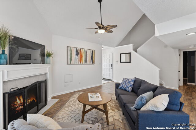 2918 Ranch Road 620th Rd N Unit C122, Austin, TX 78734 - living area with wood finished floors, ceiling fan, high vaulted ceiling, a fireplace, and baseboards