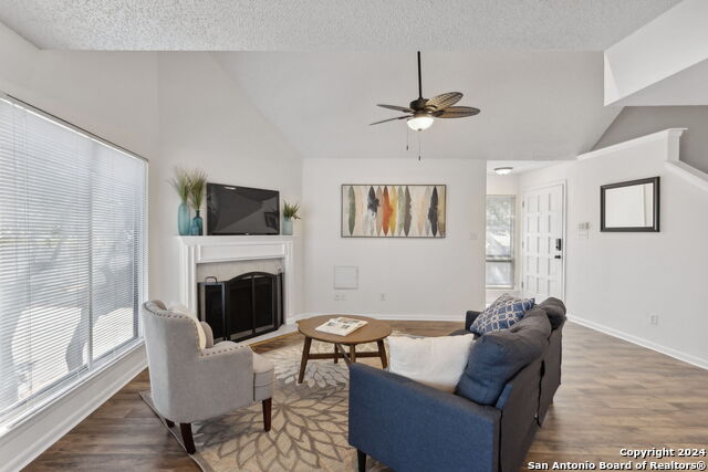 2918 Ranch Road 620th Rd N Unit C122, Austin, TX 78734 - living area featuring lofted ceiling, a ceiling fan, a fireplace, wood finished floors, and baseboards