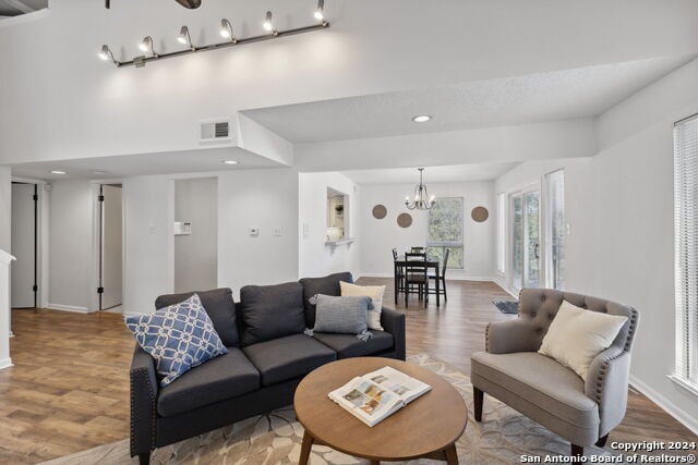 2918 Ranch Road 620th Rd N Unit C122, Austin, TX 78734 - living area with wood finished floors, a chandelier, recessed lighting, and baseboards