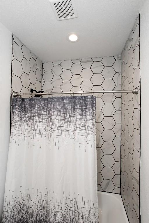 1215 Ridge Harbor Dr, Spicewood, TX 78669 - bathroom view of recessed lighting and shower / tub combo