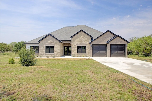1215 Ridge Harbor Dr, Spicewood, TX 78669 - french provincial home featuring stone siding, french doors, an attached garage, a front lawn, and driveway