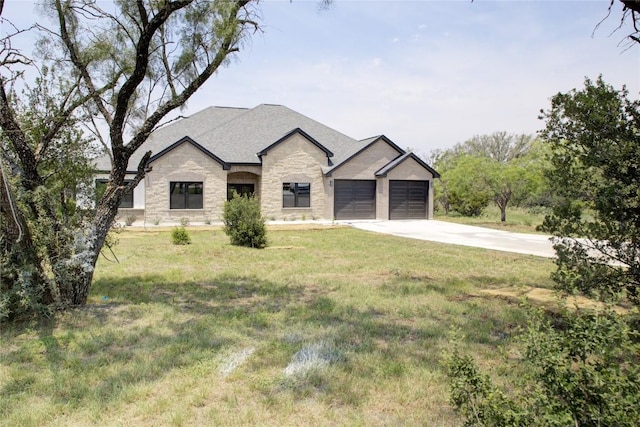 1215 Ridge Harbor Dr, Spicewood, TX 78669 - french country inspired facade featuring stone siding, concrete driveway, a garage, and a front yard