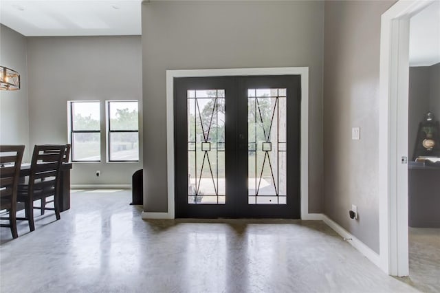 1215 Ridge Harbor Dr, Spicewood, TX 78669 - entrance foyer with french doors, healthy amount of natural light, finished concrete flooring, and baseboards