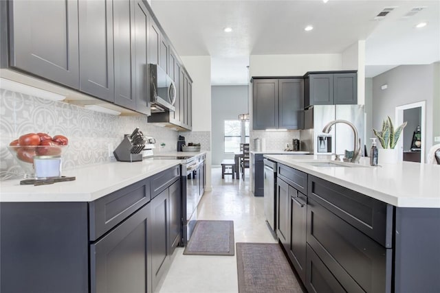 1215 Ridge Harbor Dr, Spicewood, TX 78669 - kitchen featuring stainless steel appliances, a sink, light countertops, decorative backsplash, and recessed lighting