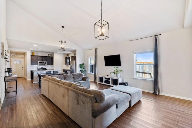 208 Shiner Ln, Georgetown, TX 78626 - living room with dark wood-style floors, a chandelier, baseboards, high vaulted ceiling, and recessed lighting
