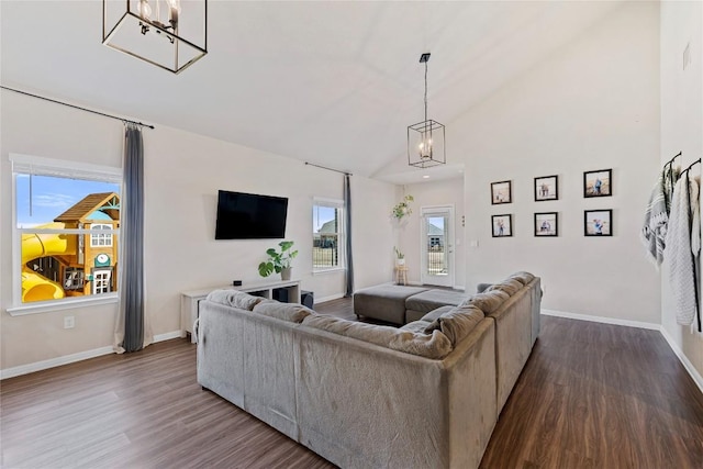 208 Shiner Ln, Georgetown, TX 78626 - living room featuring a chandelier, dark wood-style flooring, lofted ceiling, and baseboards