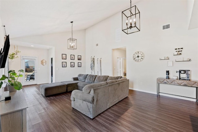 208 Shiner Ln, Georgetown, TX 78626 - living room with a chandelier, dark wood-style flooring, baseboards, and high vaulted ceiling