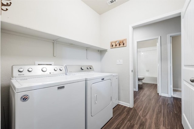 208 Shiner Ln, Georgetown, TX 78626 - laundry room with washing machine and clothes dryer, dark wood-type flooring, and baseboards