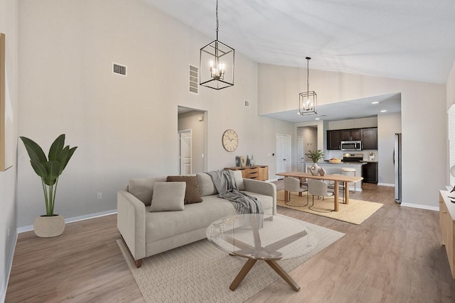 208 Shiner Ln, Georgetown, TX 78626 - living area with a chandelier, light wood-type flooring, and high vaulted ceiling