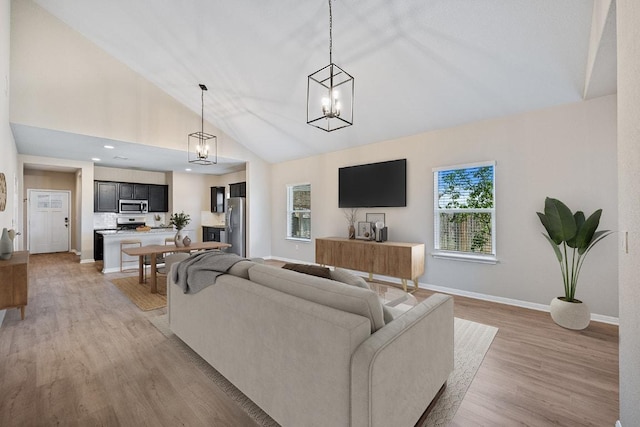 208 Shiner Ln, Georgetown, TX 78626 - living area with vaulted ceiling, light wood-type flooring, and a chandelier