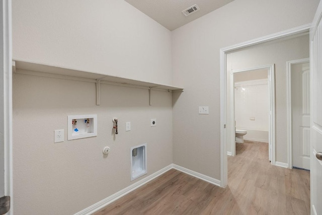 208 Shiner Ln, Georgetown, TX 78626 - laundry area with hookup for a gas dryer, light wood-style flooring, washer hookup, and electric dryer hookup