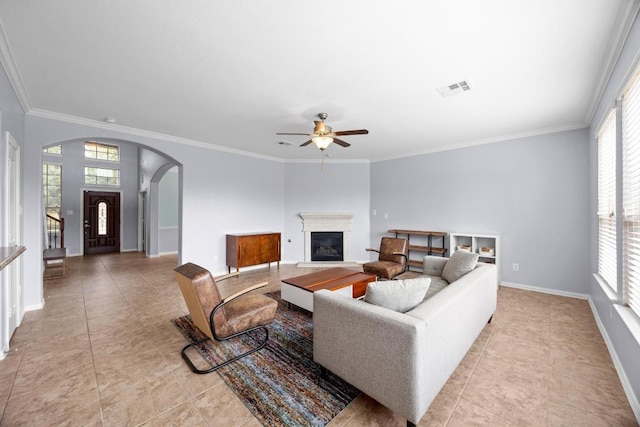 2817 Dusty Chisolm Trl, Pflugerville, TX 78660 - living room with plenty of natural light, light tile patterned floors, a ceiling fan, and ornamental molding