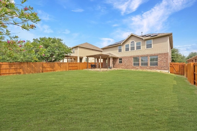 2817 Dusty Chisolm Trl, Pflugerville, TX 78660 - back of property featuring roof mounted solar panels, brick siding, and a patio area