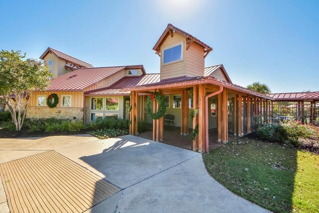 2817 Dusty Chisolm Trl, Pflugerville, TX 78660 - view of front of house with a standing seam roof, metal roof, and stone siding
