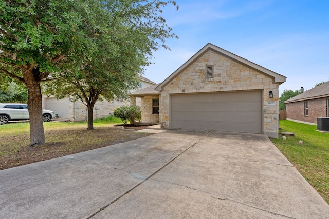 11117 Boundless Valley Dr, Austin, TX 78754 - view of front of property with stone siding, driveway, a front lawn, central AC unit, and an attached garage