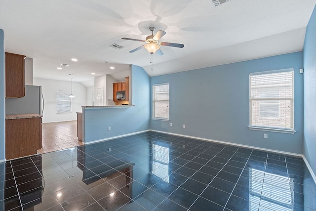 11117 Boundless Valley Dr, Austin, TX 78754 - unfurnished living room featuring dark tile patterned floors, ceiling fan, baseboards, and recessed lighting
