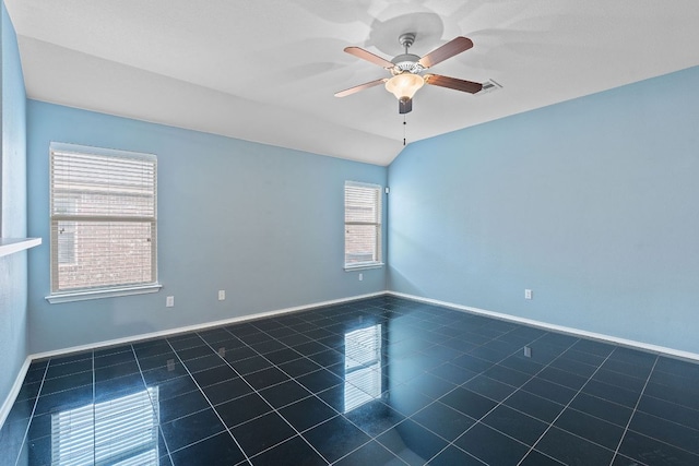 11117 Boundless Valley Dr, Austin, TX 78754 - empty room with dark tile patterned flooring, a ceiling fan, and baseboards