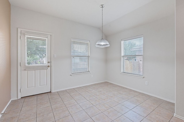 11117 Boundless Valley Dr, Austin, TX 78754 - unfurnished dining area with light tile patterned flooring and baseboards