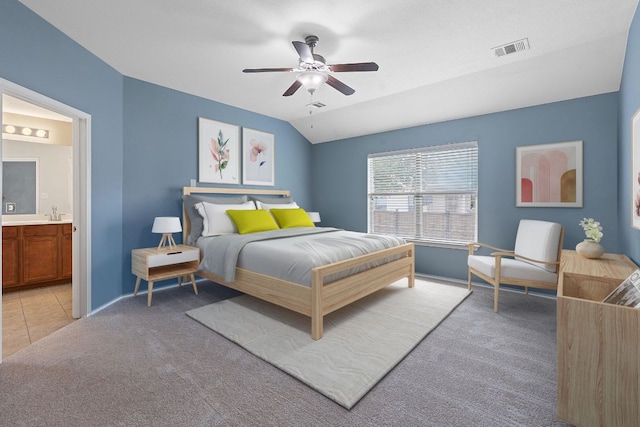 11117 Boundless Valley Dr, Austin, TX 78754 - bedroom with light carpet, connected bathroom, baseboards, a ceiling fan, and vaulted ceiling