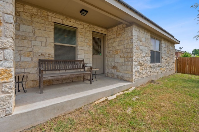 11117 Boundless Valley Dr, Austin, TX 78754 - view of exterior entry with stone siding and covered porch