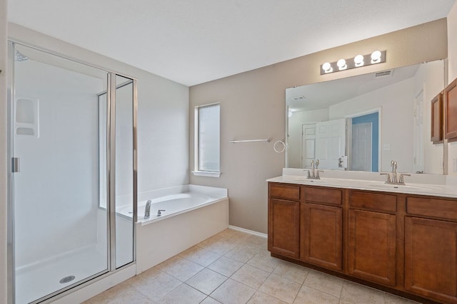 11117 Boundless Valley Dr, Austin, TX 78754 - full bathroom with a stall shower, a bath, double vanity, tile patterned floors, and baseboards