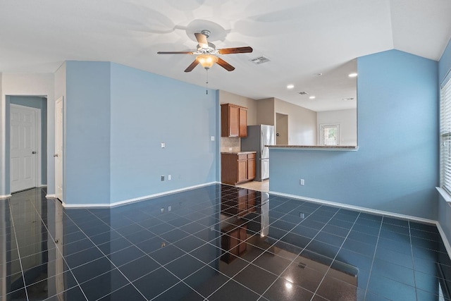 11117 Boundless Valley Dr, Austin, TX 78754 - unfurnished living room featuring a ceiling fan, baseboards, dark tile patterned floors, and recessed lighting