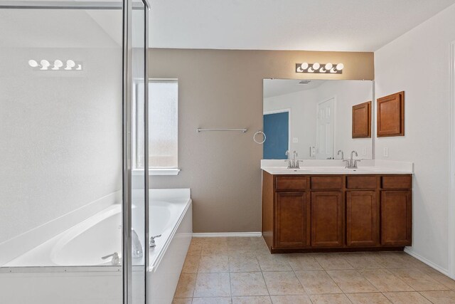 11117 Boundless Valley Dr, Austin, TX 78754 - full bath featuring a bath, double vanity, tile patterned floors, and baseboards