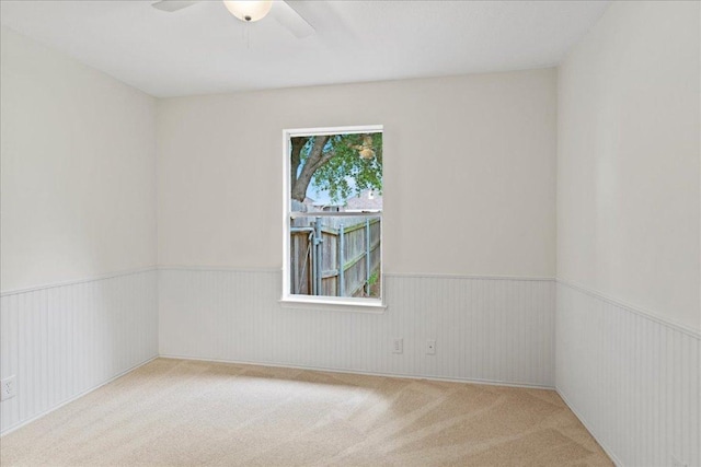 16900 Abyssinian Ln, Round Rock, TX 78681 - spare room featuring carpet floors, a ceiling fan, and wainscoting